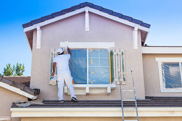 Contact busy house painter painting the trim and shutters of a home.