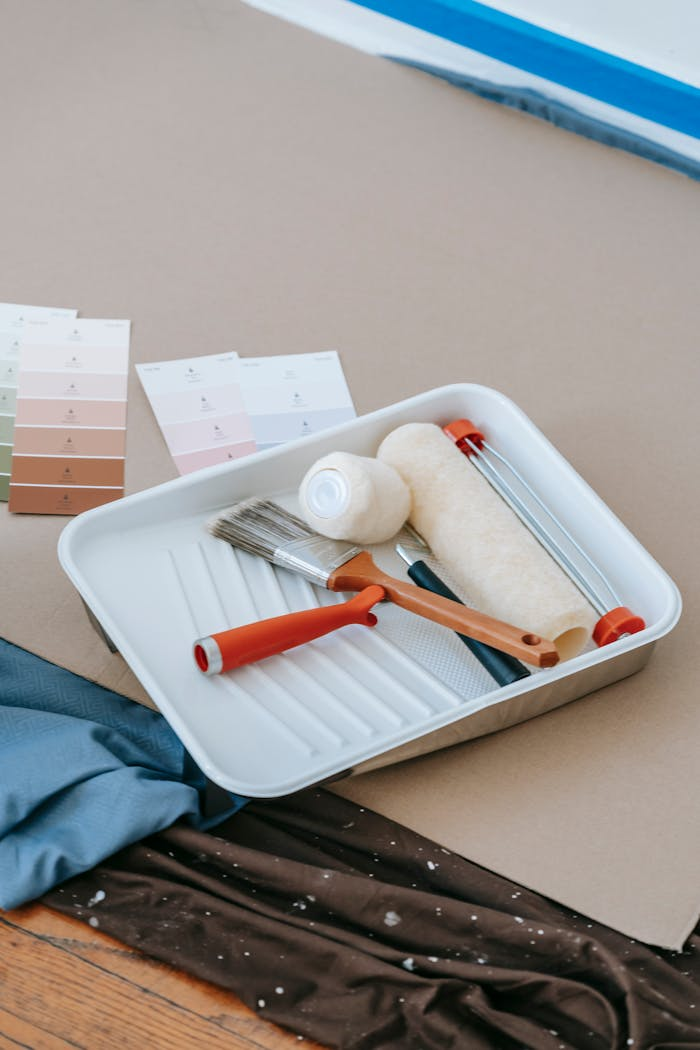 Home Paintbrush, roller, tray, and swatches for home renovation projects.